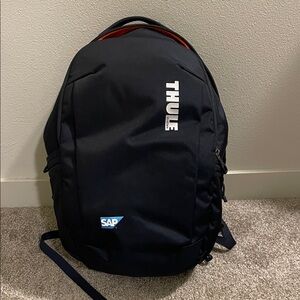 Thule Black Backpack with White Logo and Blue SAP Badge